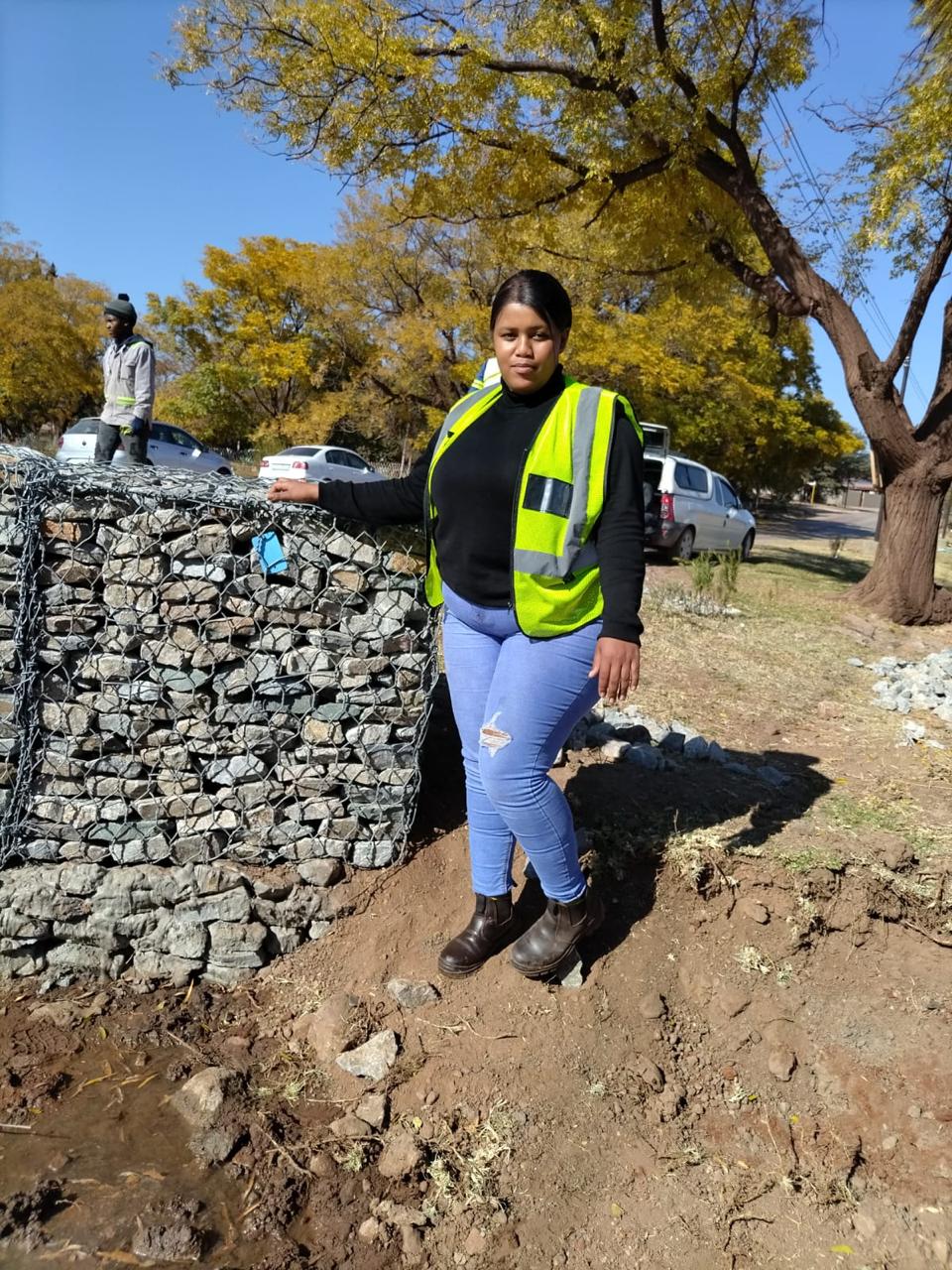 Team member beside completed gabion work